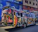 A brightly wrapped vehicle showcasing vibrant colors and sharp graphics on city streets.