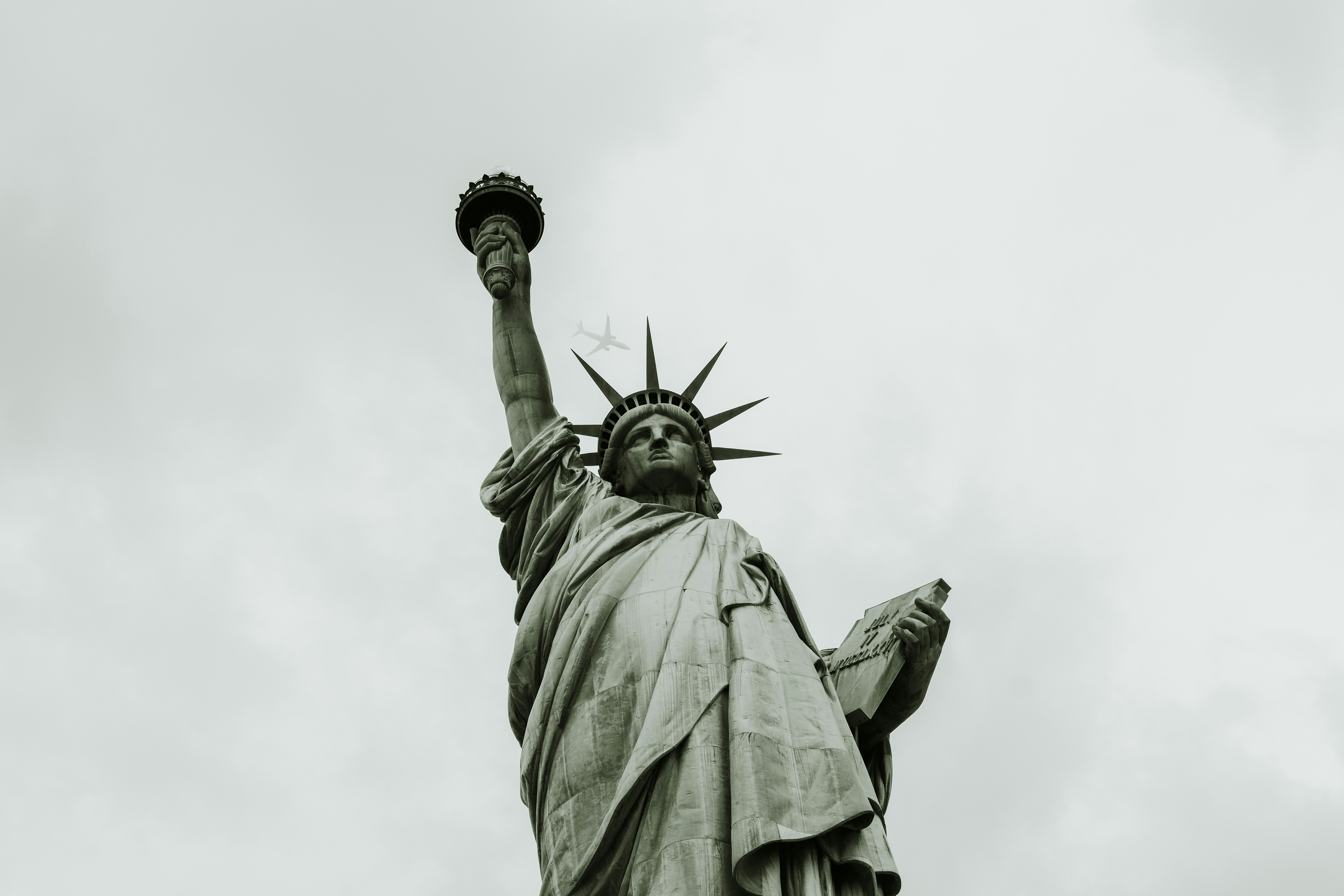In 2014, I took a trip to New York for the cliche and touristy site seeing ventures. On a foggy day, we went to the Statue of Liberty. Trying to create various angles, I stood just a bit off to the side and tilted my camera upwards. After a handful of shots, and shifting the camera’s angel, I saw an airplane in the top left corner of the frame. It appeared and disappeared within the clouds. So, in hopes that I could perhaps capture it near the statue, I took a bunch of photos. Then, this happened. Yes, it’s not perfectly centered between the crown, but still // a new angle on the same statue.