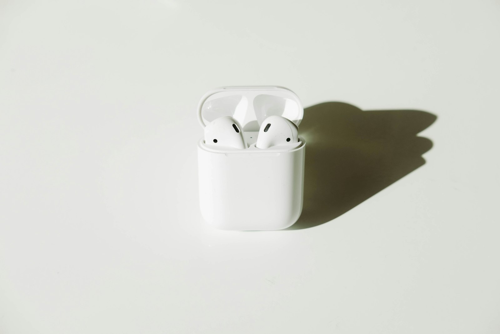 A pair of wireless earbuds sitting in an open charging case