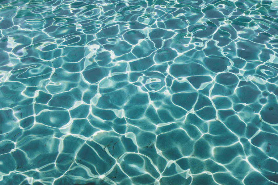 Sunlight reflecting on clear blue pool water