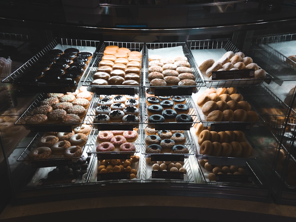 assorted-topping doughnuts on trays