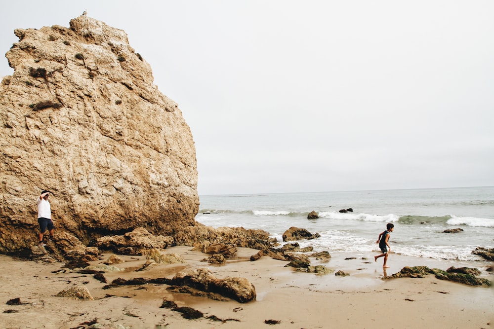 boy running in front of beach