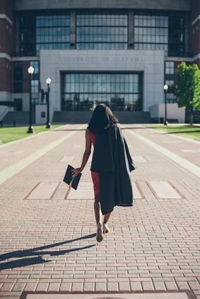 woman standing at facade of Alabama University building