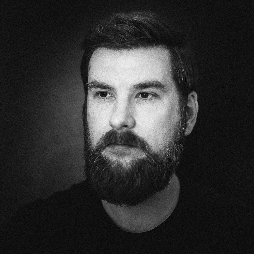 grayscale photography of man wearing crew-neck shirt