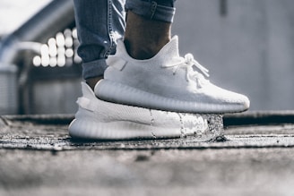 person wearing pair of cream white Adidas Yeezy Boost 350 shoes