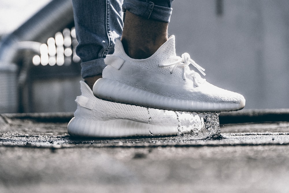person wearing pair of cream white Adidas Yeezy Boost 350 shoes