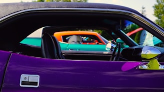 A colorful lineup of diverse cars at an auto show.