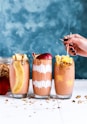 three clear drinking glass filled by shakes