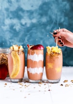 three clear drinking glass filled by shakes