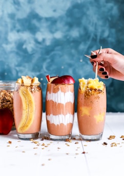 three clear drinking glass filled by shakes