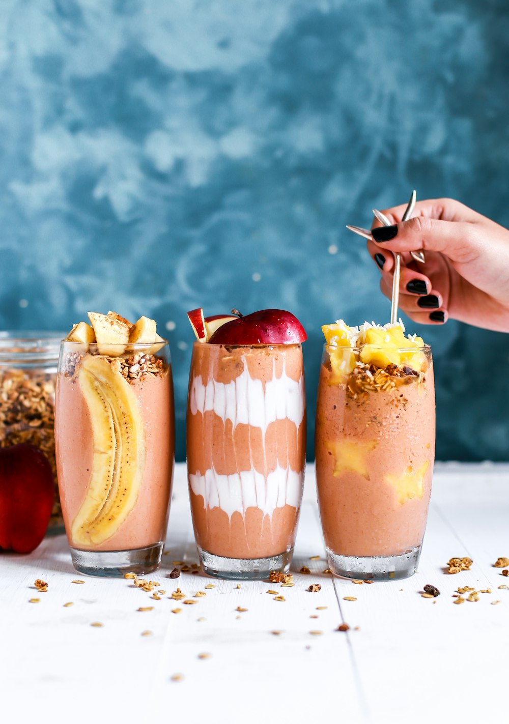 three clear drinking glass filled by shakes