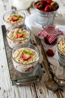 milk, strawberry, and cornflakes in glasses