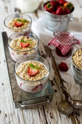 milk, strawberry, and cornflakes in glasses