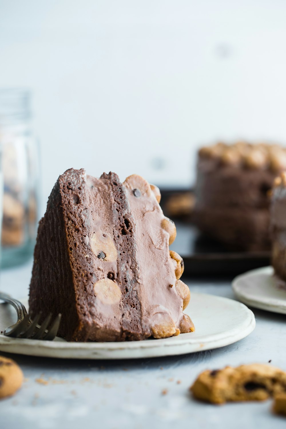 slice of chocolate cake on white ceramic saucer