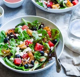 vegetable salad on white ceramic bowl