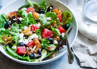 vegetable salad on white ceramic bowl