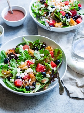 vegetable salad on white ceramic bowl