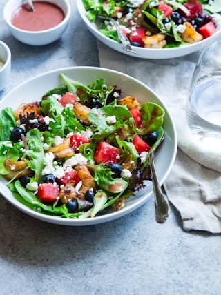 vegetable salad on white ceramic bowl