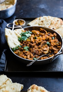 A dish of curry with naan bread