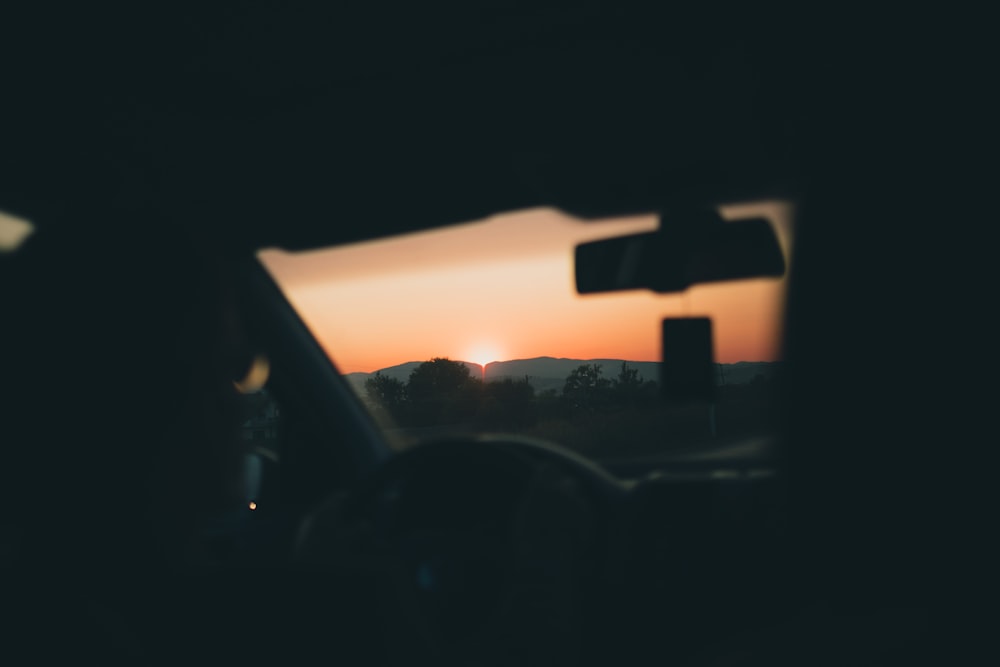 person in car seeing sunset