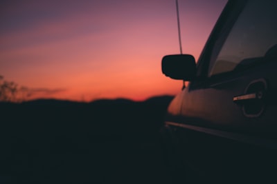 black vehicle during sunset kosovo teams background