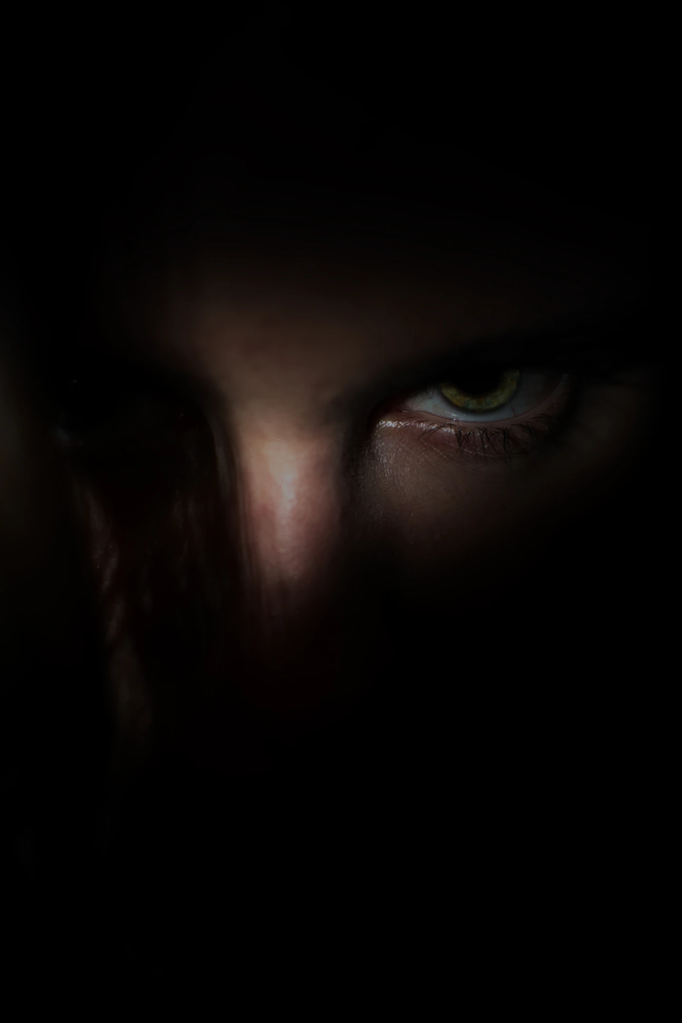 A face lit by the glow of a screen in darkness