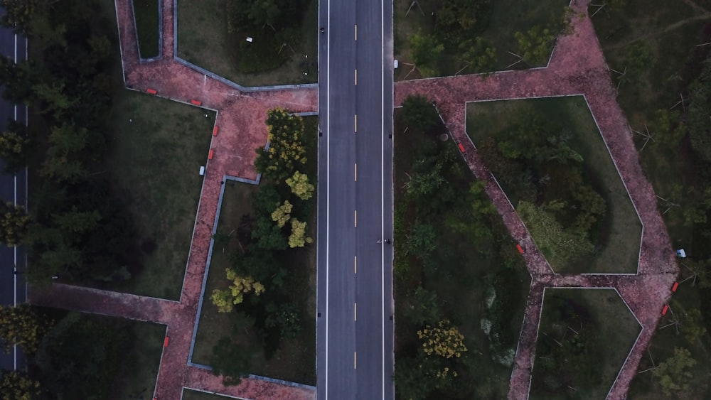 an aerial view of a road and trees