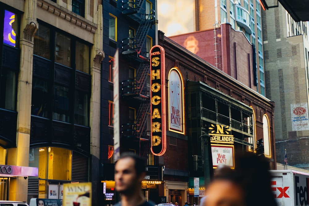 people walking beside high buildings during daytime