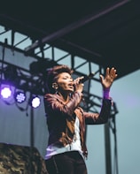 selective focus photography of woman raising left hand