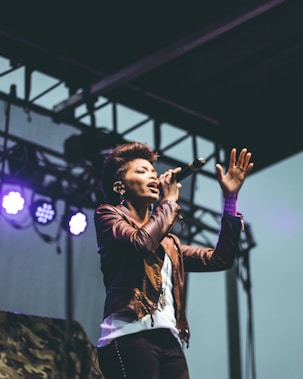 selective focus photography of woman raising left hand