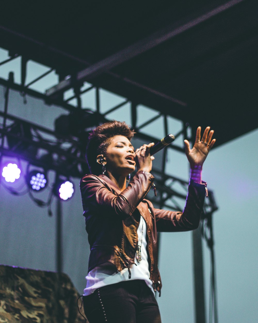 selective focus photography of woman raising left hand