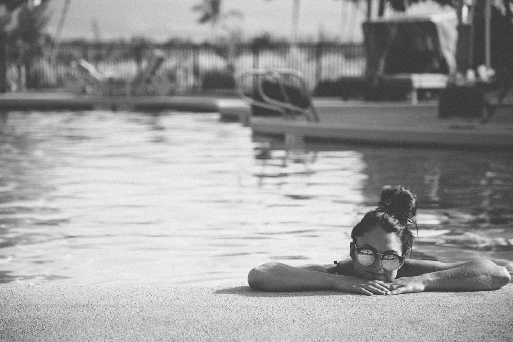 grayscale photography of woman in pool
