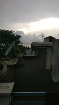 A sleek OVR-Guard unit mounted on a rooftop, scanning the sky at dusk.