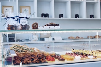 An assortment of pastries and tarts arranged invitingly on a bakery display.