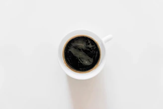 Freshly brewed specialty coffee served in a minimalist black cup.