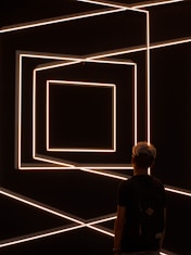 person standing in front of optical illusion wall