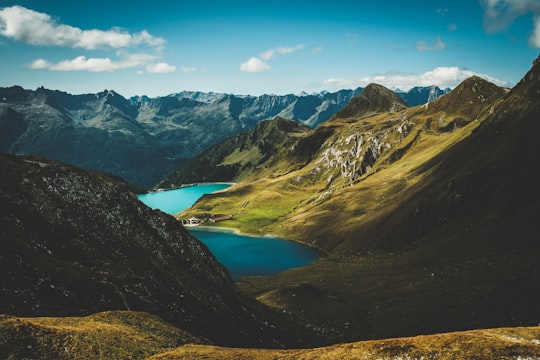 photo of body of water between mountains in Lago Ritom Switzerland