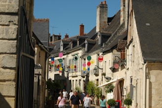 Families enjoying a sunny day at the historic streets of York, with quaint shops and cobblestone paths.