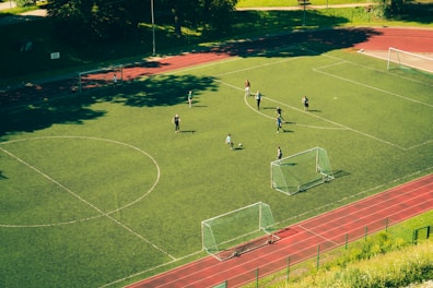 people playing soccer on soccer field