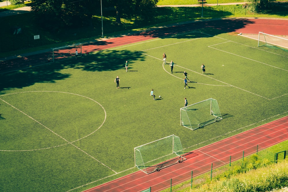 people playing soccer on soccer field