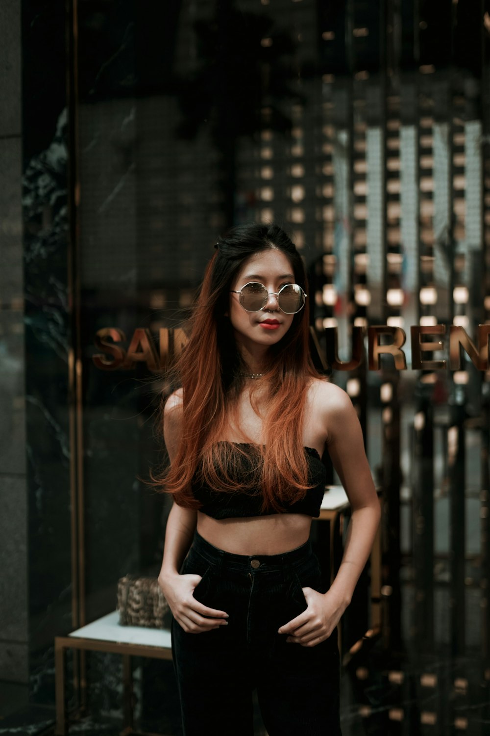 woman in black crop top standing near establishment