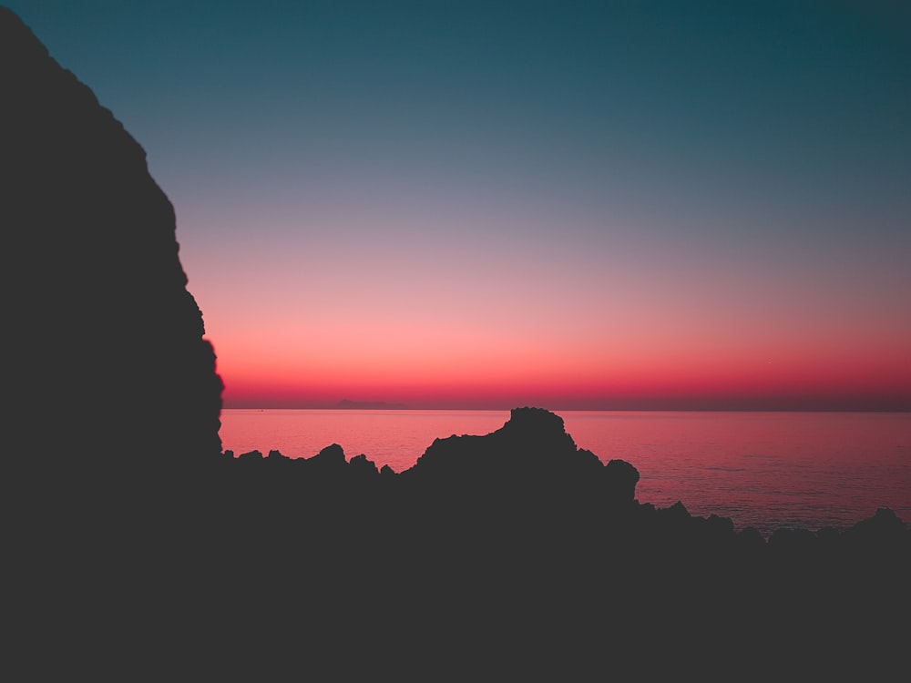 silhouette of cliff and sea