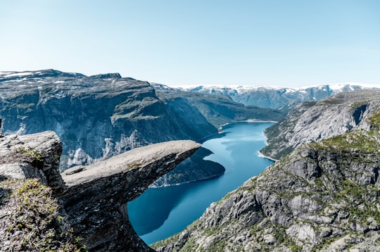 brown and green rock mountain during day time in Trolltunga Norway