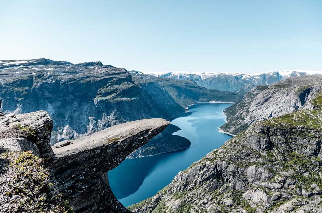 brown and green rock mountain during day time, Trolltunga