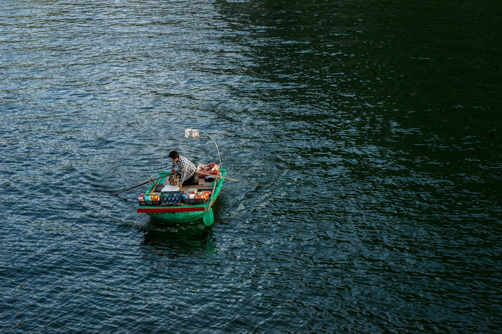 person on green boat