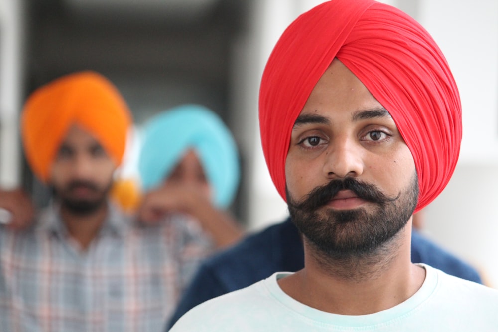 selective focus photo of man wearing red pagri headdress