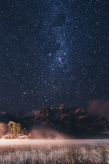 landscape photo of mountains under starry sky at nighttime