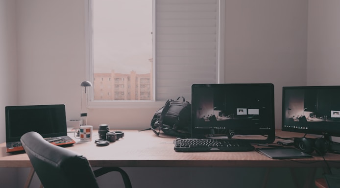 A cozy workspace with editing equipment and photography gear.