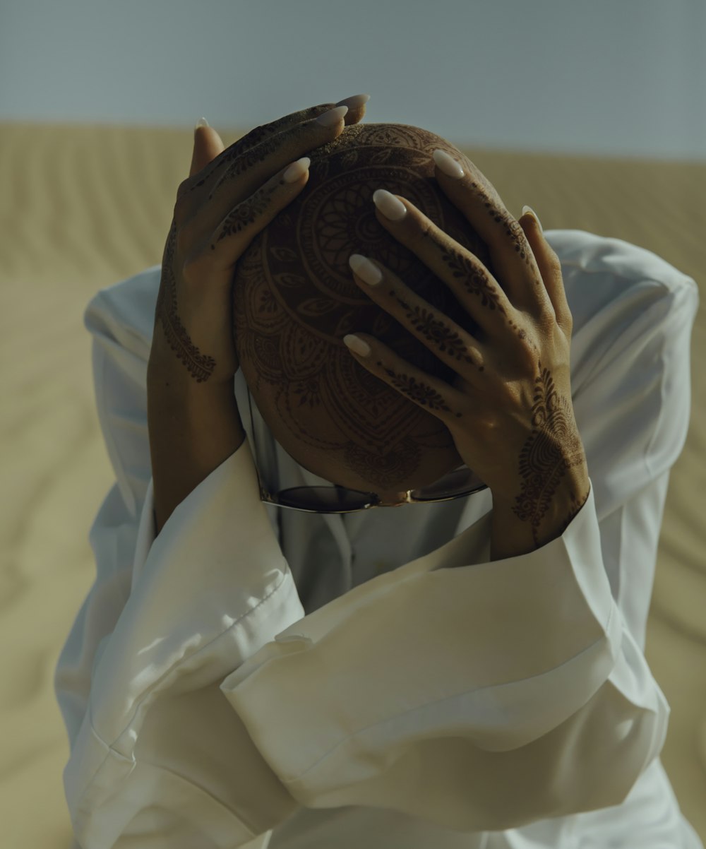 woman sitting on sand in a desert