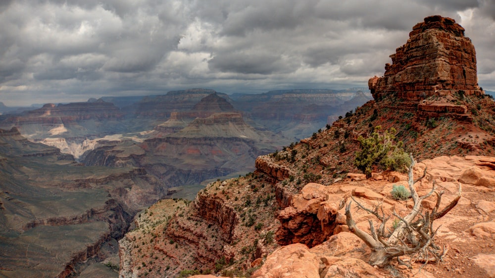 valley and mountains under white clouds during daytime